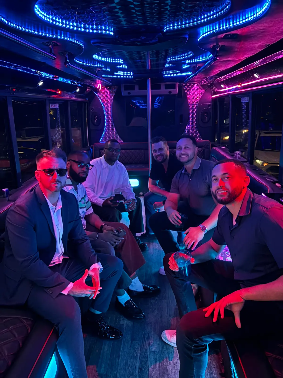 Bachelor party group in suits on party bus