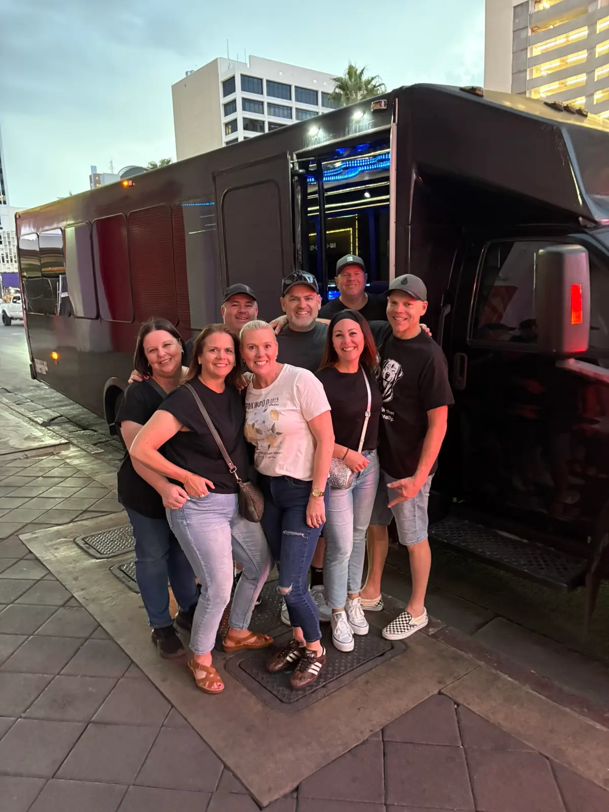 Friends group photo outside American Royalty party bus